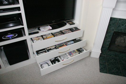 Three full extension drawers for media storage.